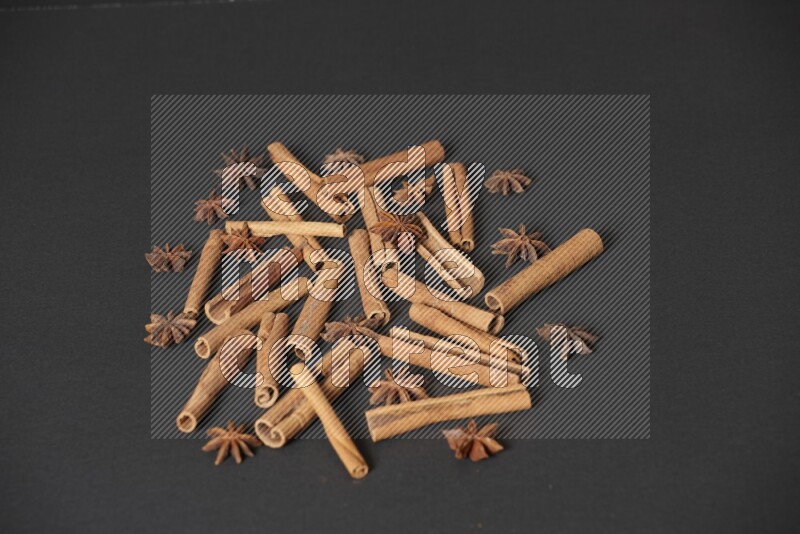 Cinnamon sticks and star anise on black background
