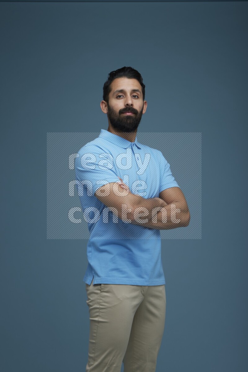 Man posing in a blue background wearing a Blue shirt