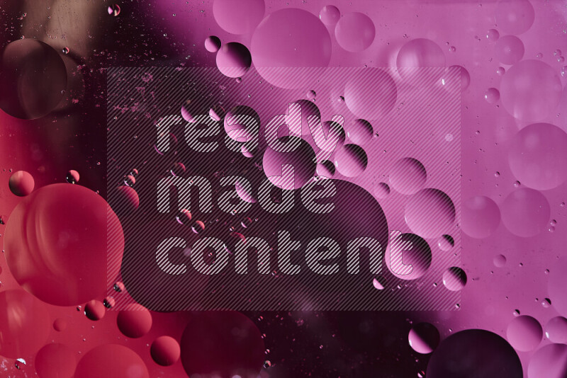 Close-ups of abstract oil bubbles on water surface in shades of red and pink