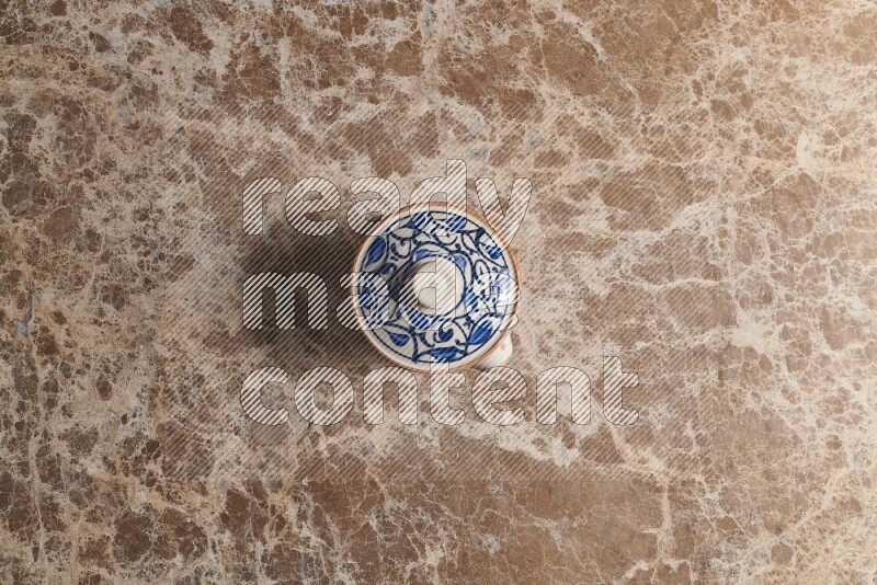 A multicolored pottery pot on beige marble background