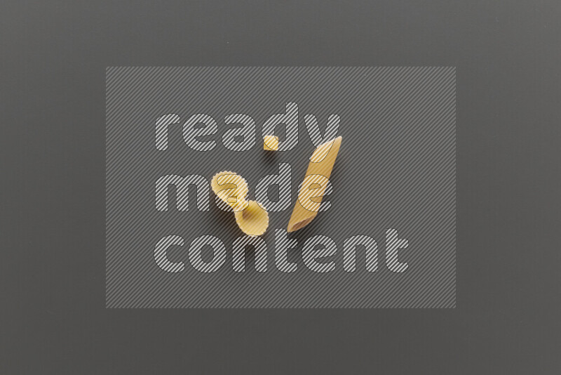 Different pasta types on grey background