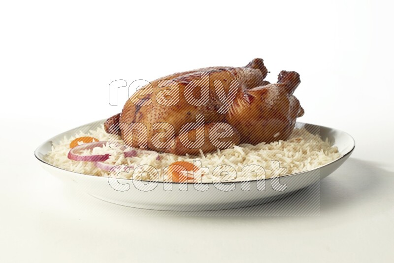 white  basmati Rice with  whole roasted chicken  on a white plate with a silver rim direct  on white background