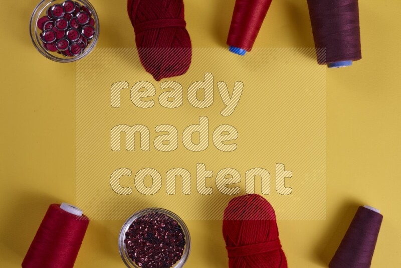 A red collection of sewing and tailoring tools arranged on a yellow background