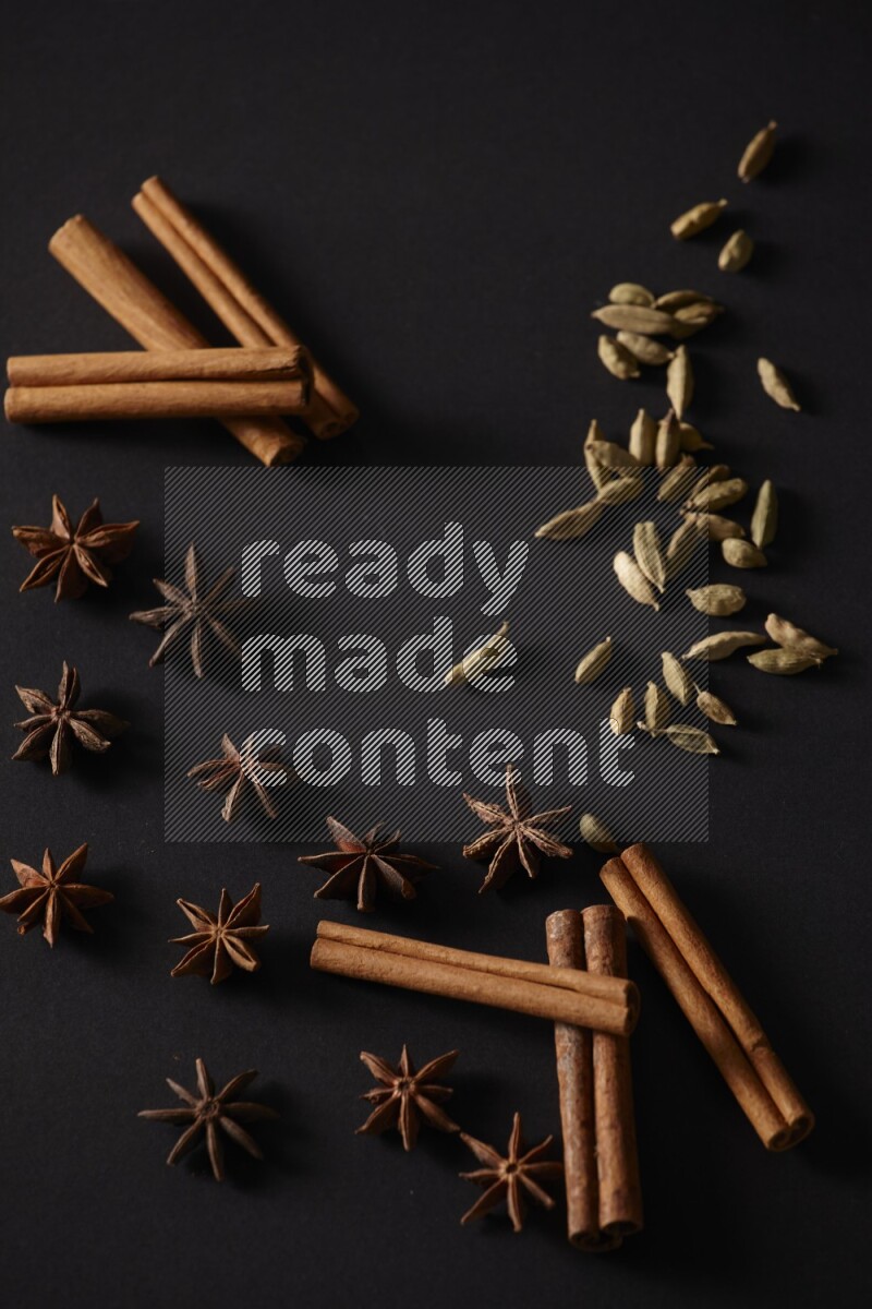 Cinnamon Sticks, Cardamom and star anise on a black background