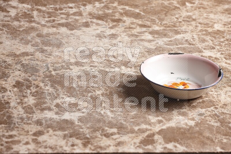 A vintage metal plate on beige marble background