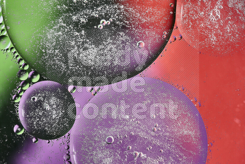 Close-ups of abstract oil bubbles on water surface in shades of purple, green and red