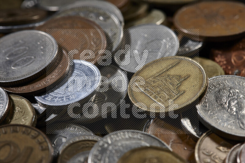 A close-ups of random old coins on black background