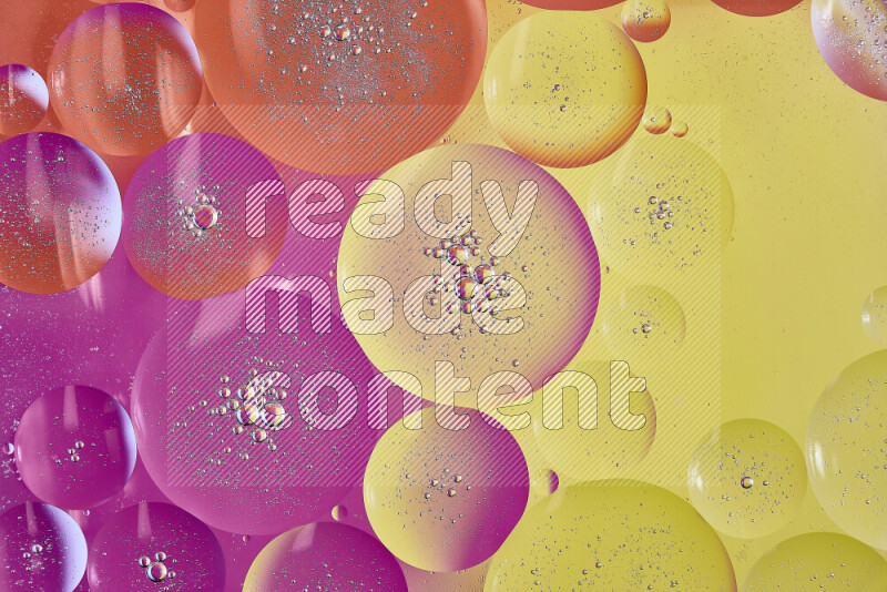 Close-ups of abstract oil bubbles on water surface in shades of yellow, orange and pink