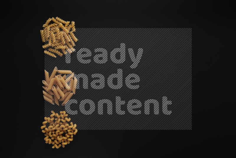 Different pasta types in 3 bunches on black background