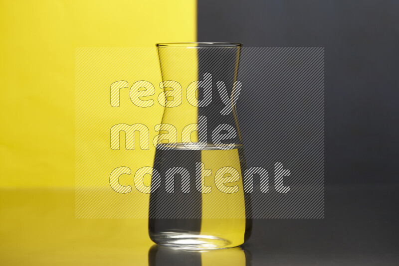 The image features a clear glassware filled with water, set against yellow and black background
