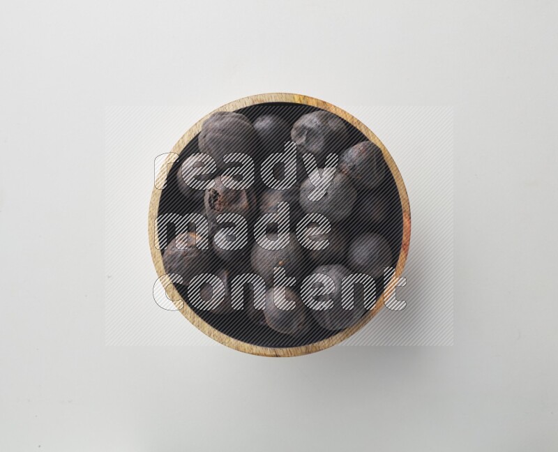 Top-view shot of dried lime (loomi) in a container on white background