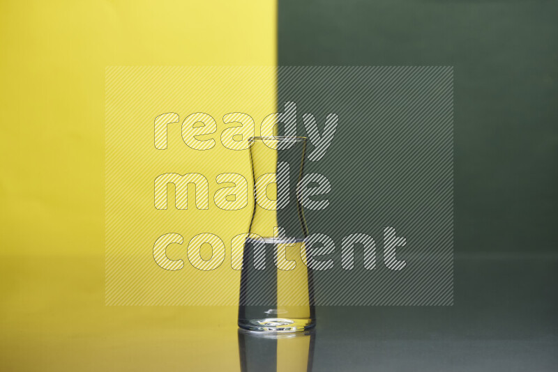 The image features a clear glassware filled with water, set against yellow and dark green background
