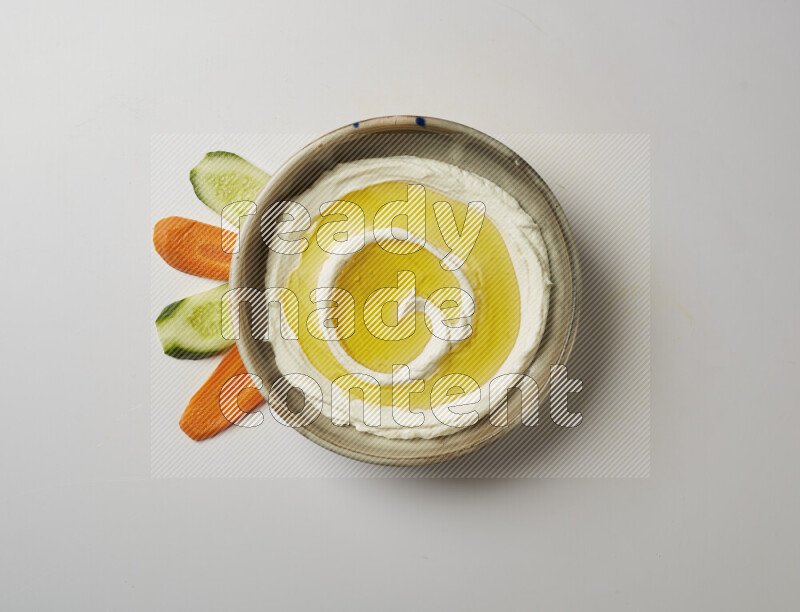 Lebnah garnished with olive oil in a grey pottery plate on a white background