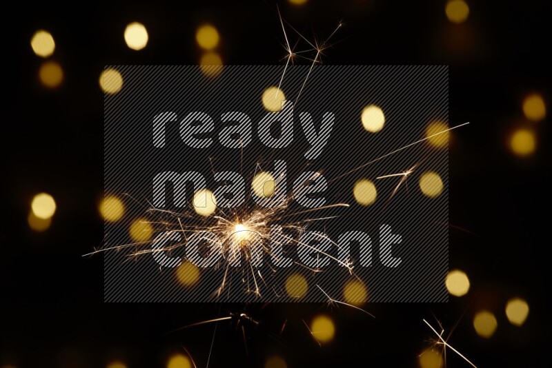 Sparkler candle with yellow light bokeh background