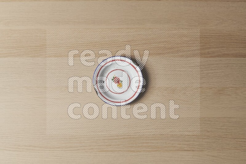 A vintage metal plate on light wooden background