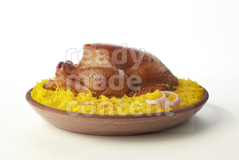 yellow basmati Rice with whole roasted chicken  on a pottery plate  direct  on white background
