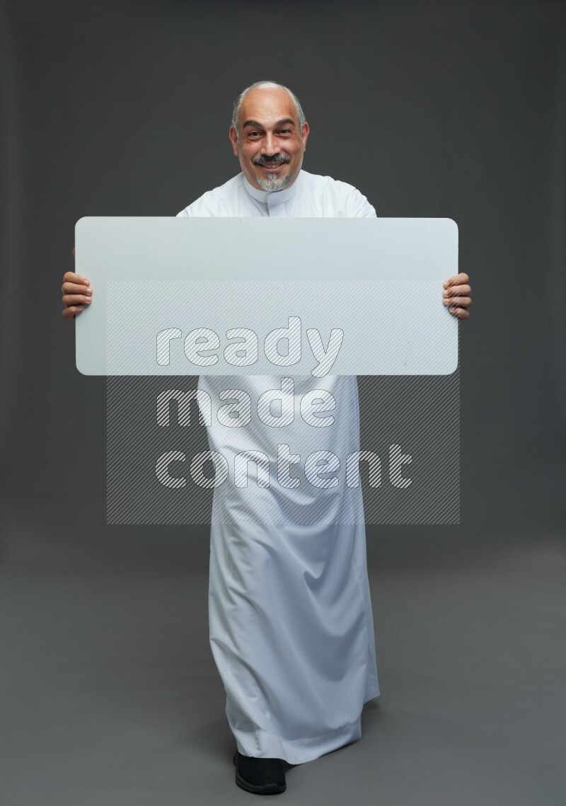 Saudi man without shomag Standing holding social media sing on gray background
