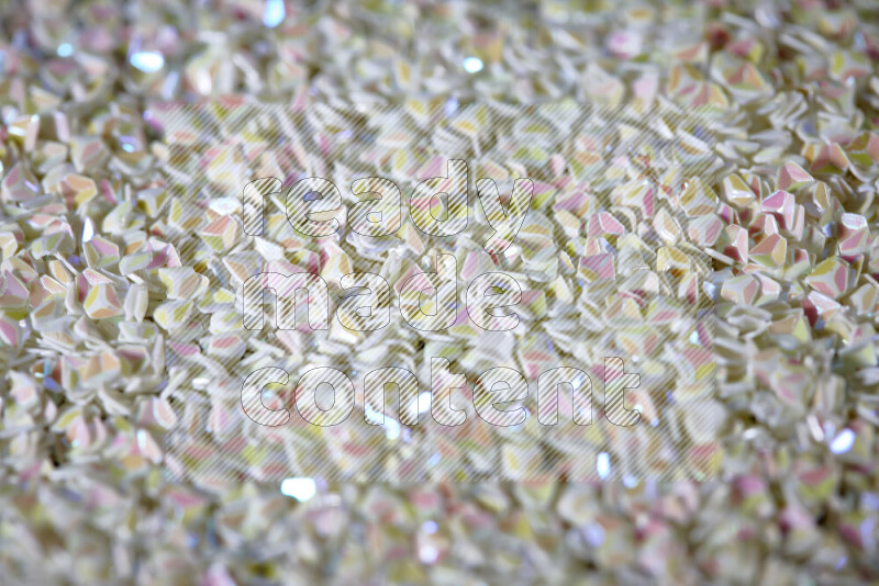 Colorful plastic shards for decoration scattered on a black background