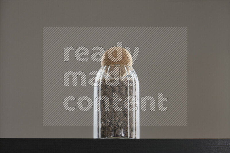 Buttons in a glass jar on black background