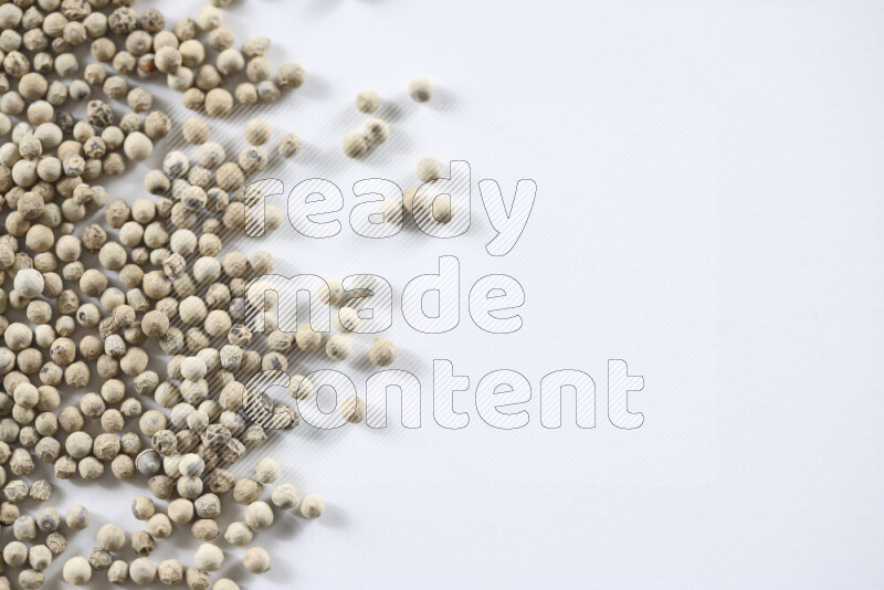 White pepper beads on white background