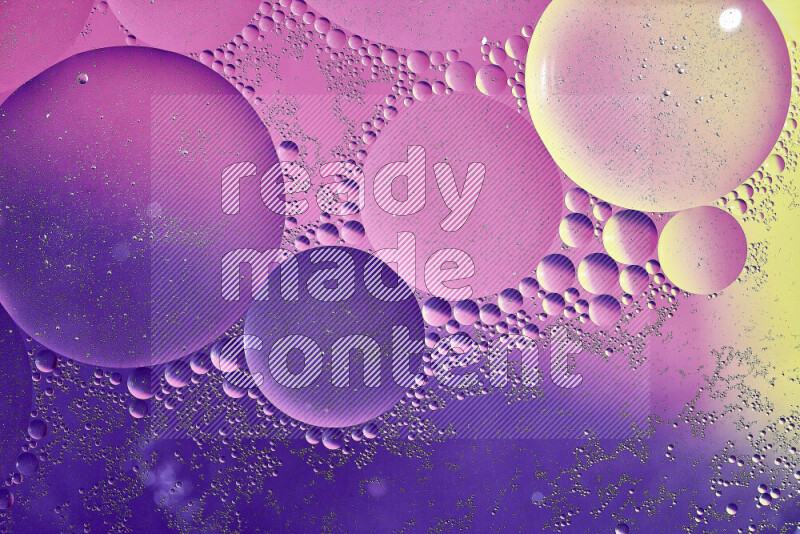 Close-ups of abstract oil bubbles on water surface in shades of yellow, purple and pink