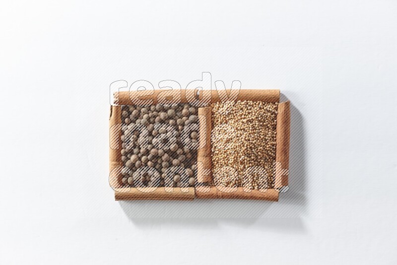 2 squares of cinnamon sticks full of mustard seeds and allspice on white flooring