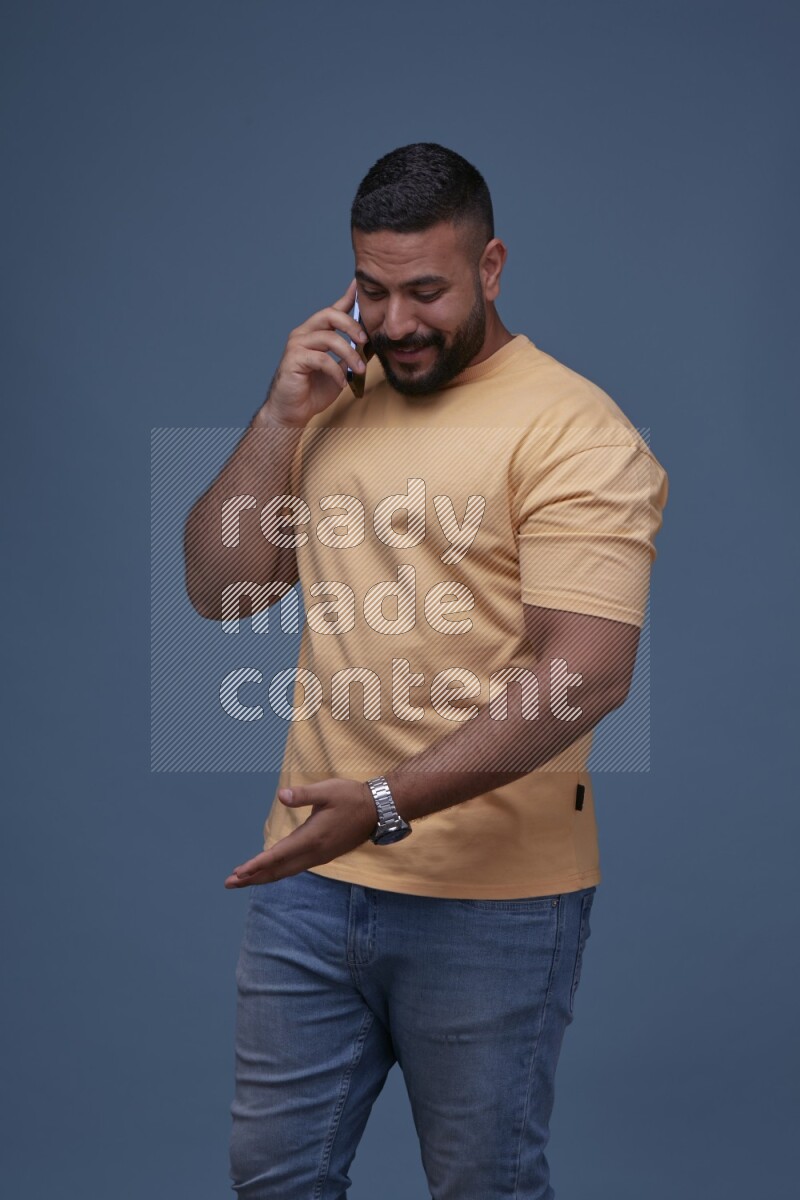 A man Calling on Blue Background wearing Orange T-shirt