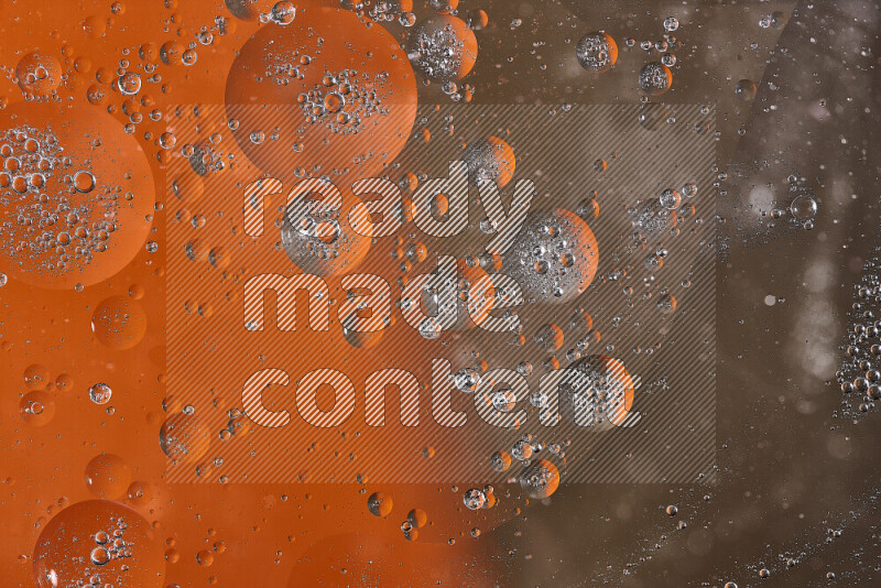Close-ups of abstract oil bubbles on water surface in shades of orange and brown