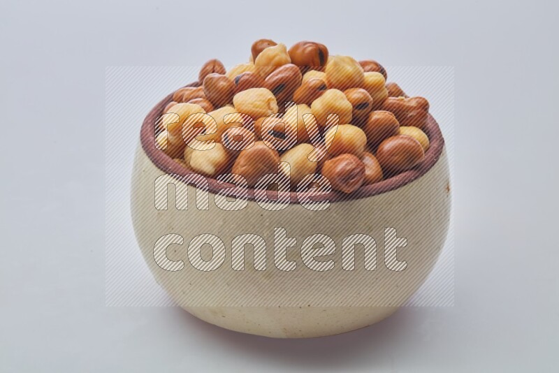 Close up shot of cooked fava beans (foul) & chickpeas on white background