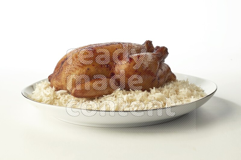 white  basmati Rice with  whole roasted chicken  on a white plate with a silver rim direct  on white background