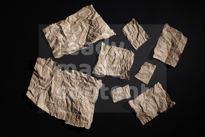 Crumpled craft paper on black background