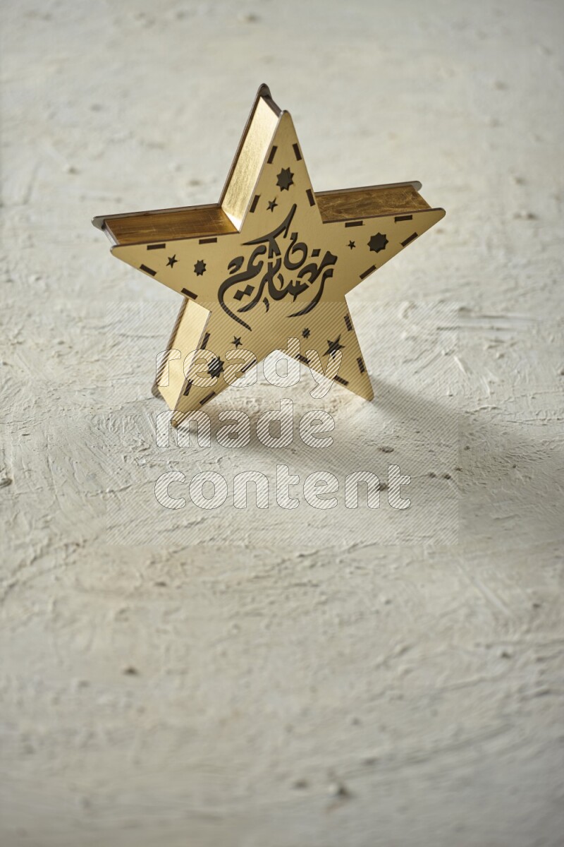A lantern placed on a textured white background
