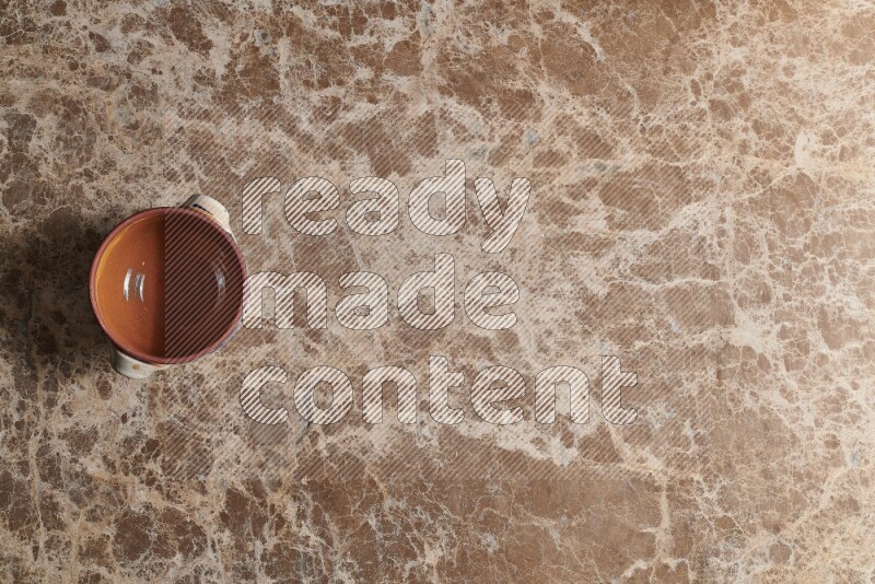 A multicolored pottery pot on beige marble background