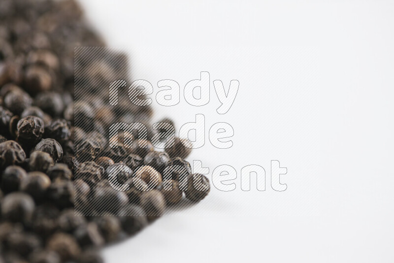Black pepper beads on white background