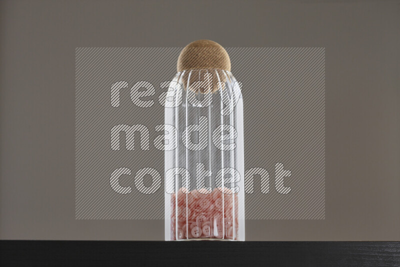 Buttons in a glass jar on black background