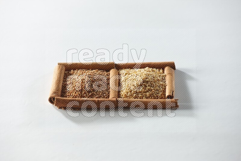 2 squares of cinnamon sticks full of mustard seeds and sesame on white flooring