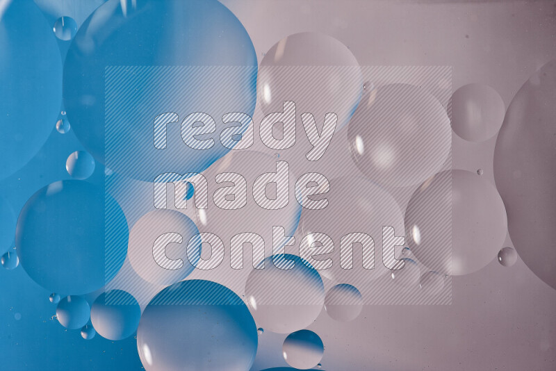 Close-ups of abstract oil bubbles on water surface in shades of white and blue
