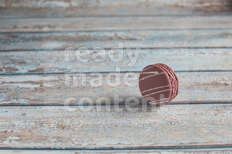 45º Shot of Red Poppy Flower macaron on light blue wooden background