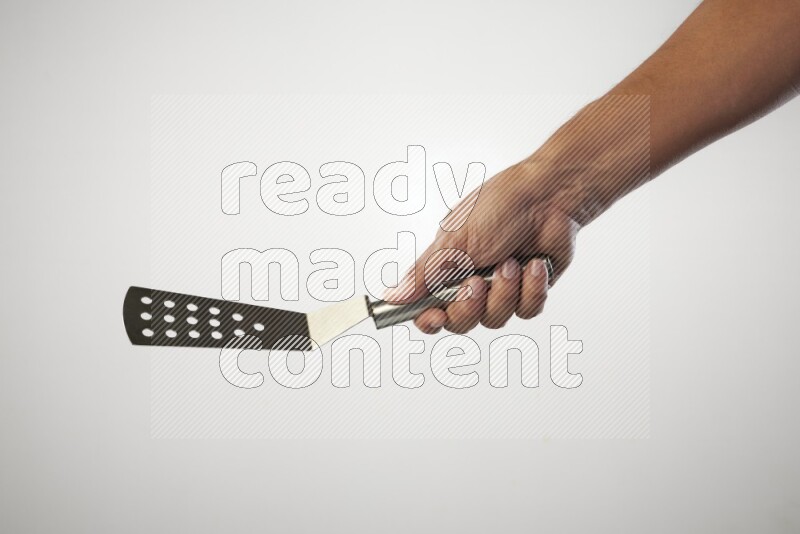 Male Hand Holding Burger Flipper on white background