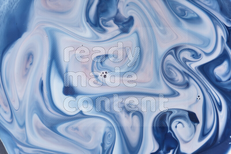 A close-up of abstract swirling patterns in blue, red and white