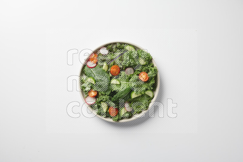 A bowl of fresh vegetables salad with kale leaves, cherry tomatoes, sliced radishes and sliced cucumber on a white background