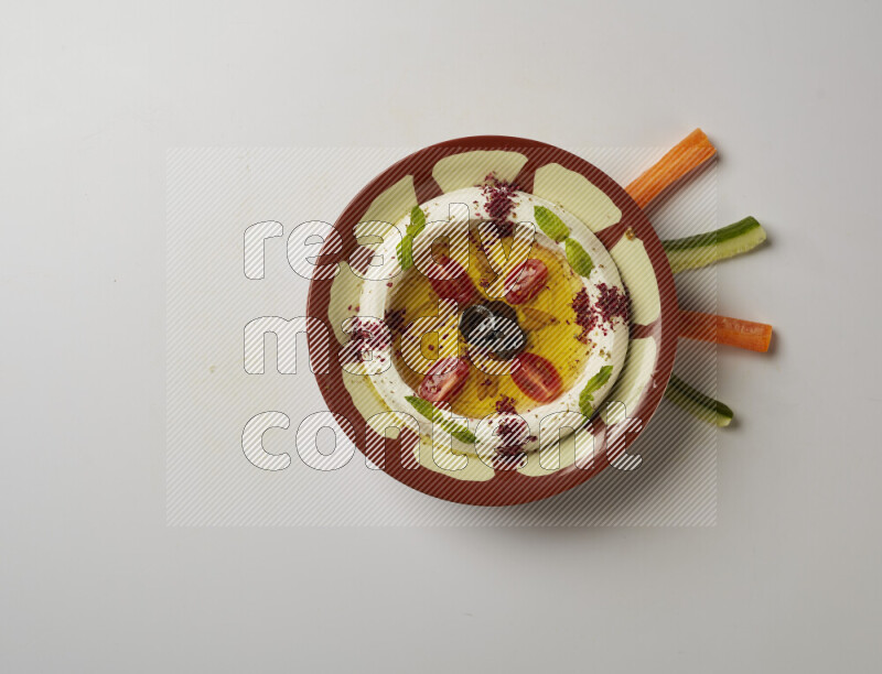 Lebnah garnished with Cherry tomato, mint & sumak  in a traditional plate on a white background