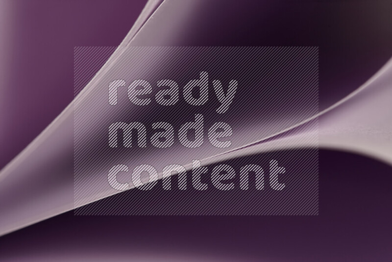 An abstract art showing purple paper sheets arranged in an overlapping curves
