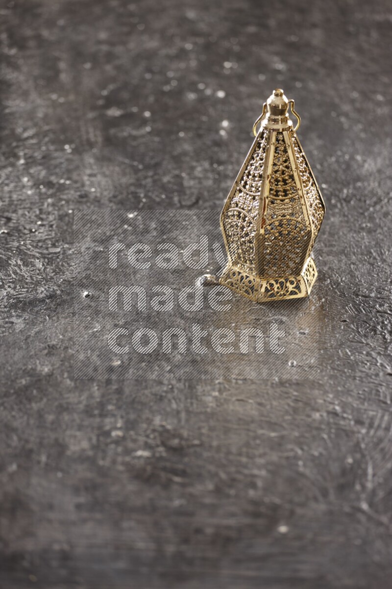 A lantern placed on a textured black background