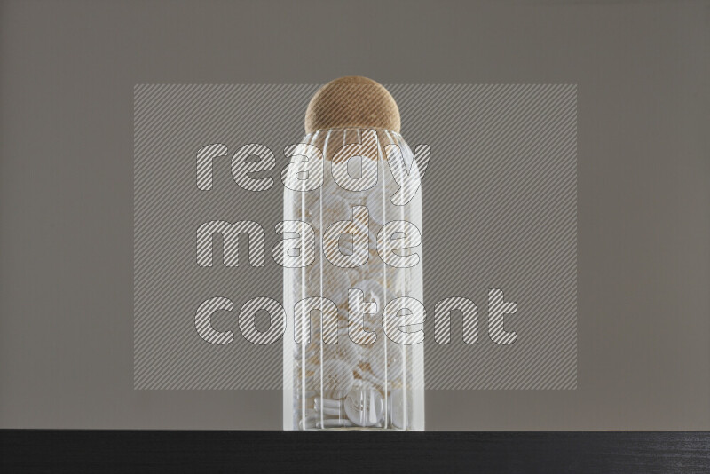 Buttons in a glass jar on black background