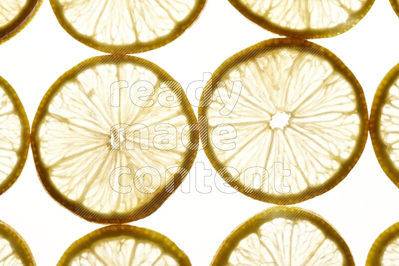 Lemon slices on illuminated white background