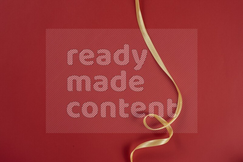 A yellow collection of sewing and tailoring tools arranged on a red background