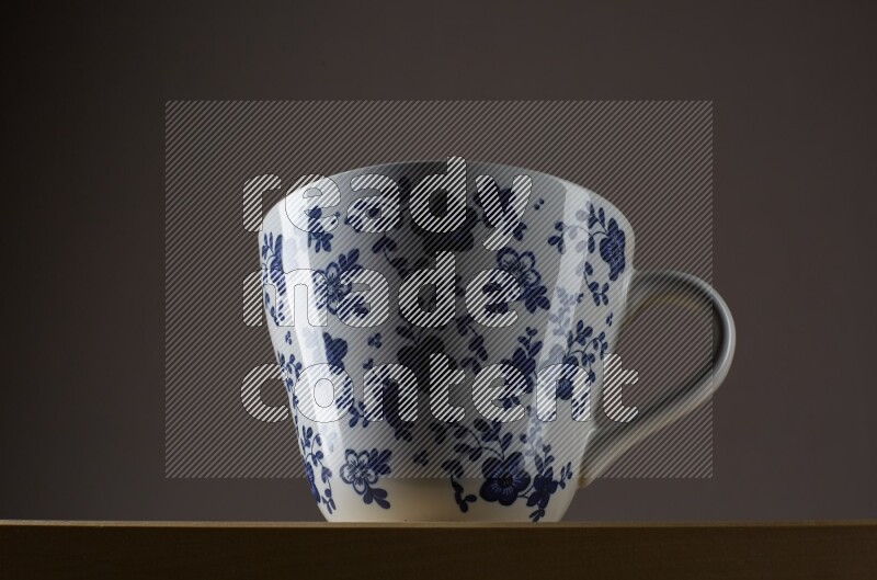 Low angle shot of a decorated cup on grey background