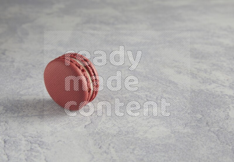 45º Shot of Red Velvet macaron on white  marble background