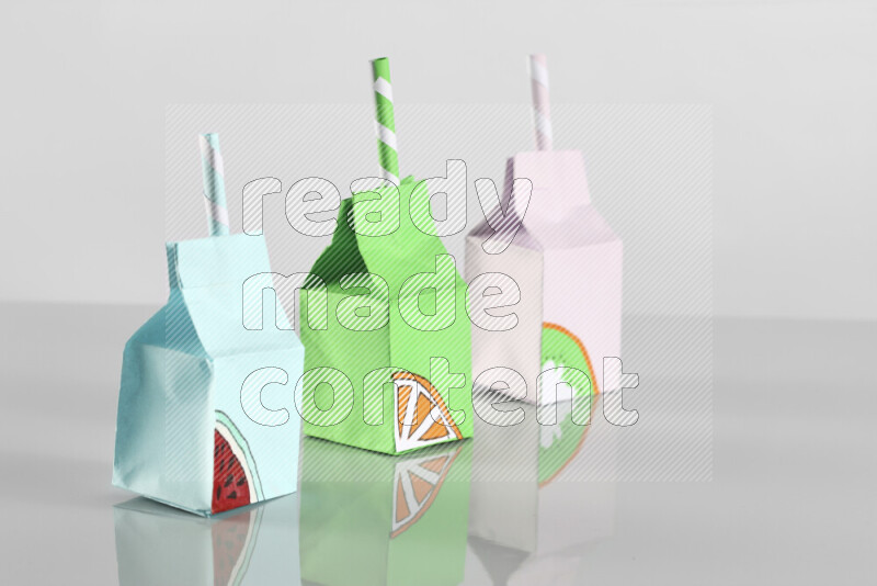 Origami juice box on grey background